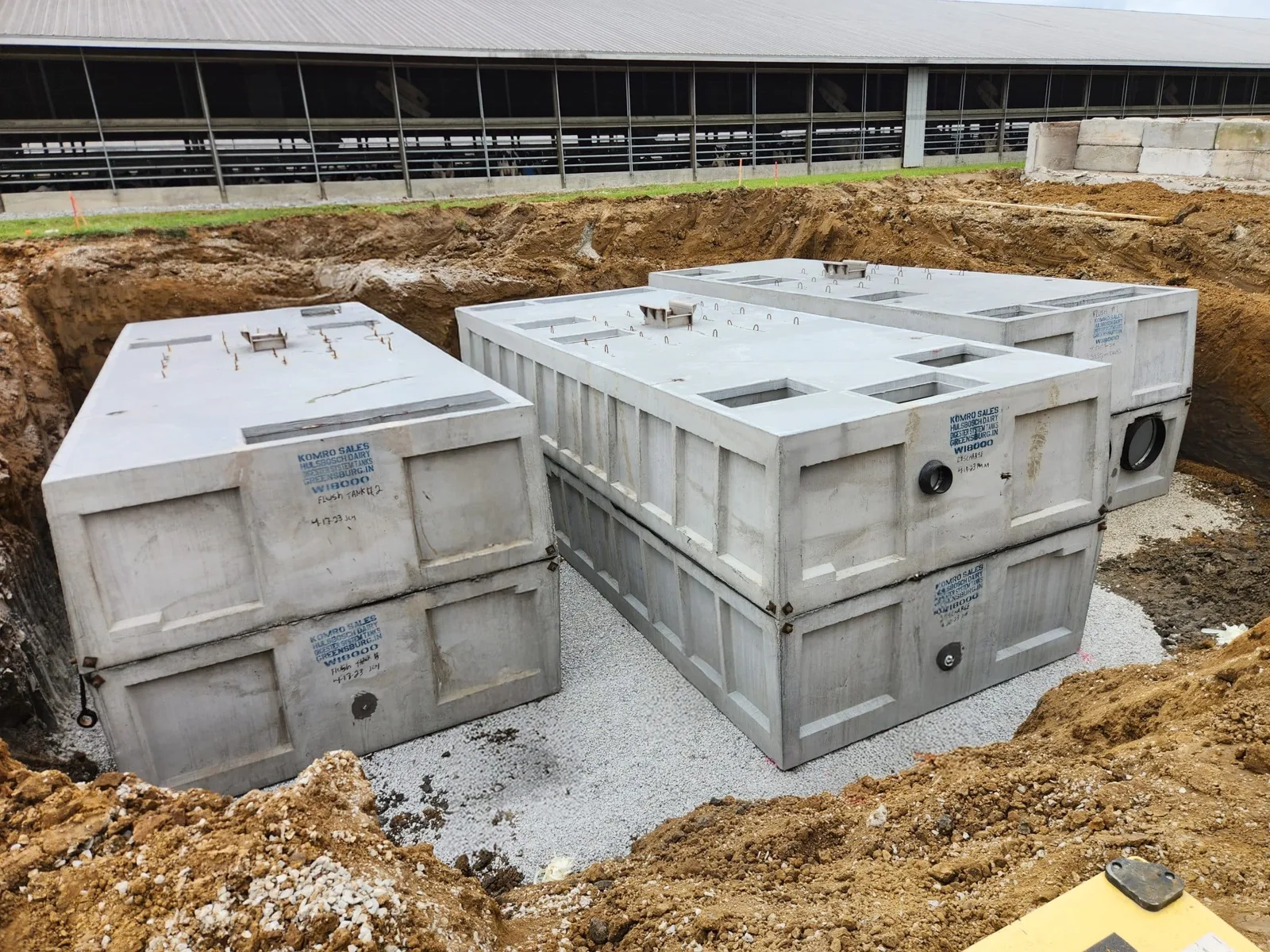 Multiple precast concrete tanks set for a commercial septic system