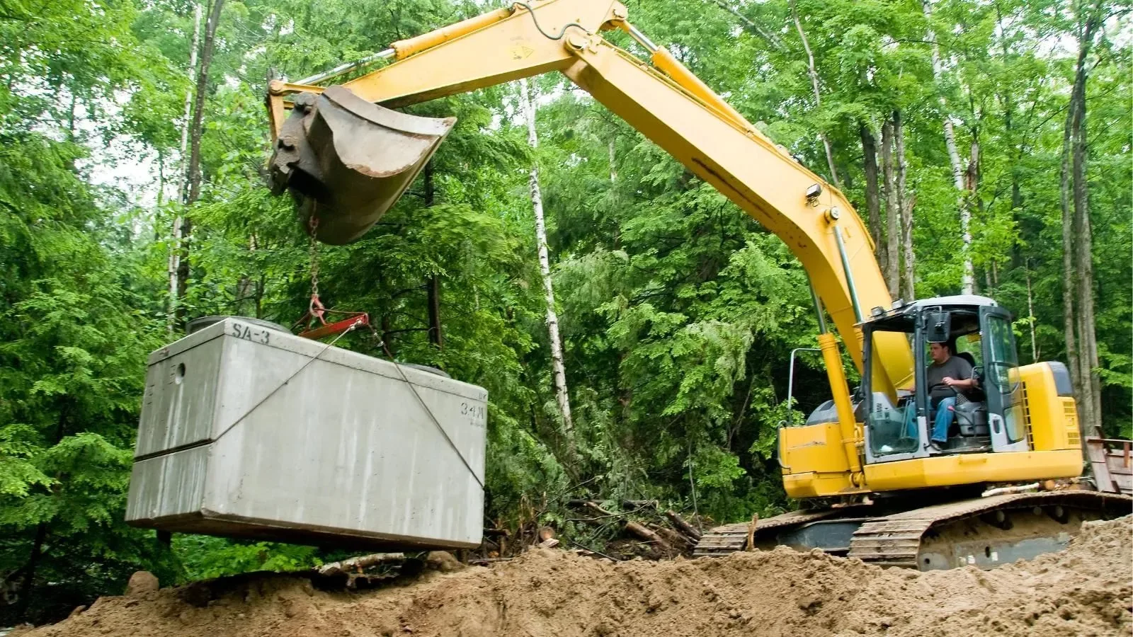 Septic system installation in Piedmont, AL with field line trench dug toward the drain field